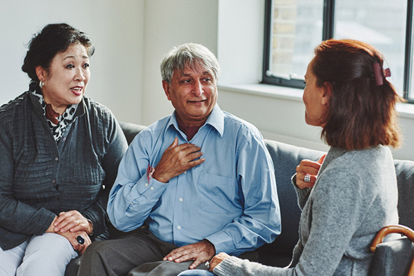 Female carer treating senior couple